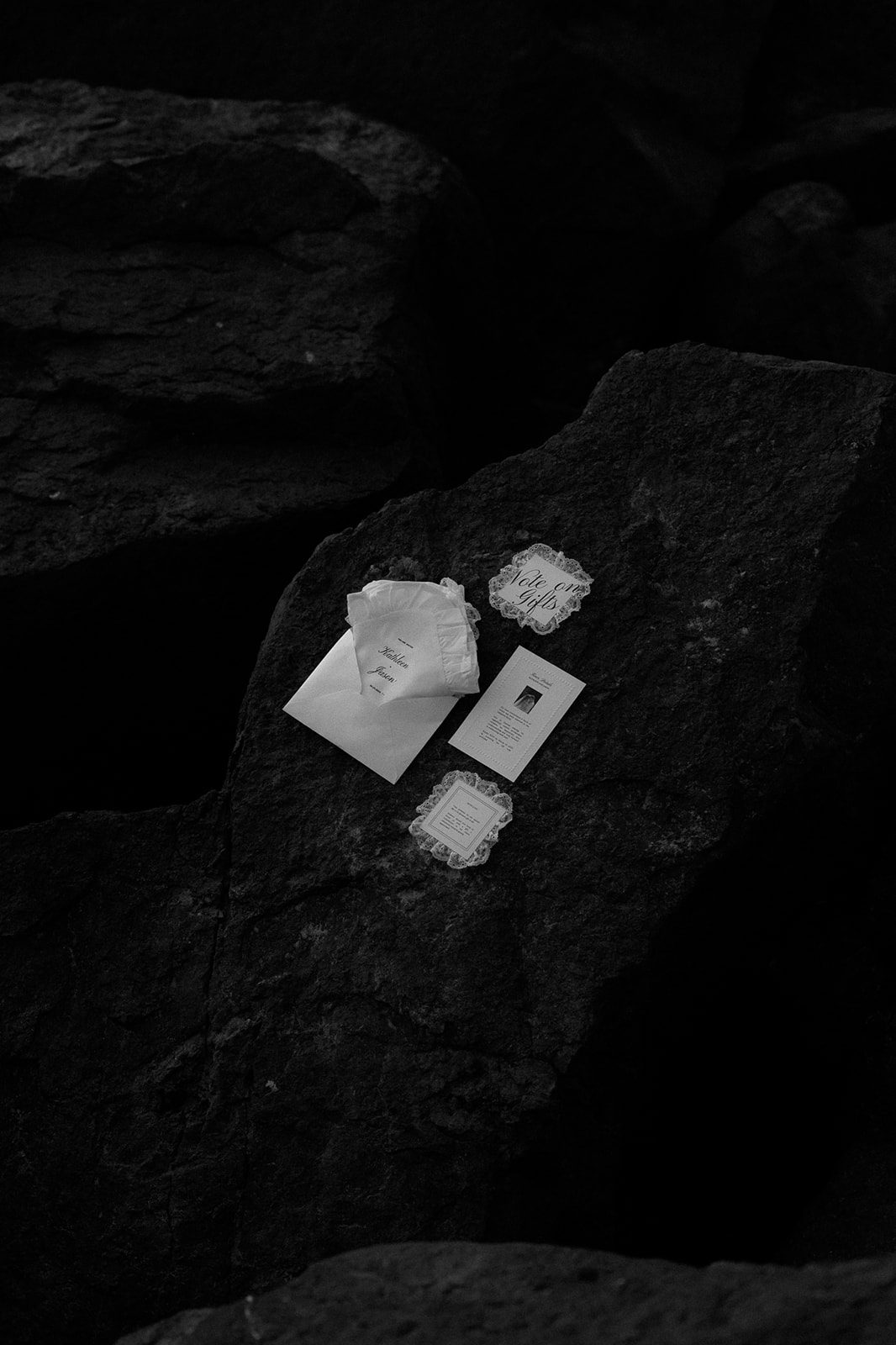 Luxury fashion-forward wedding invitation suite with lace cards on dark rock, UTWÖ Studio